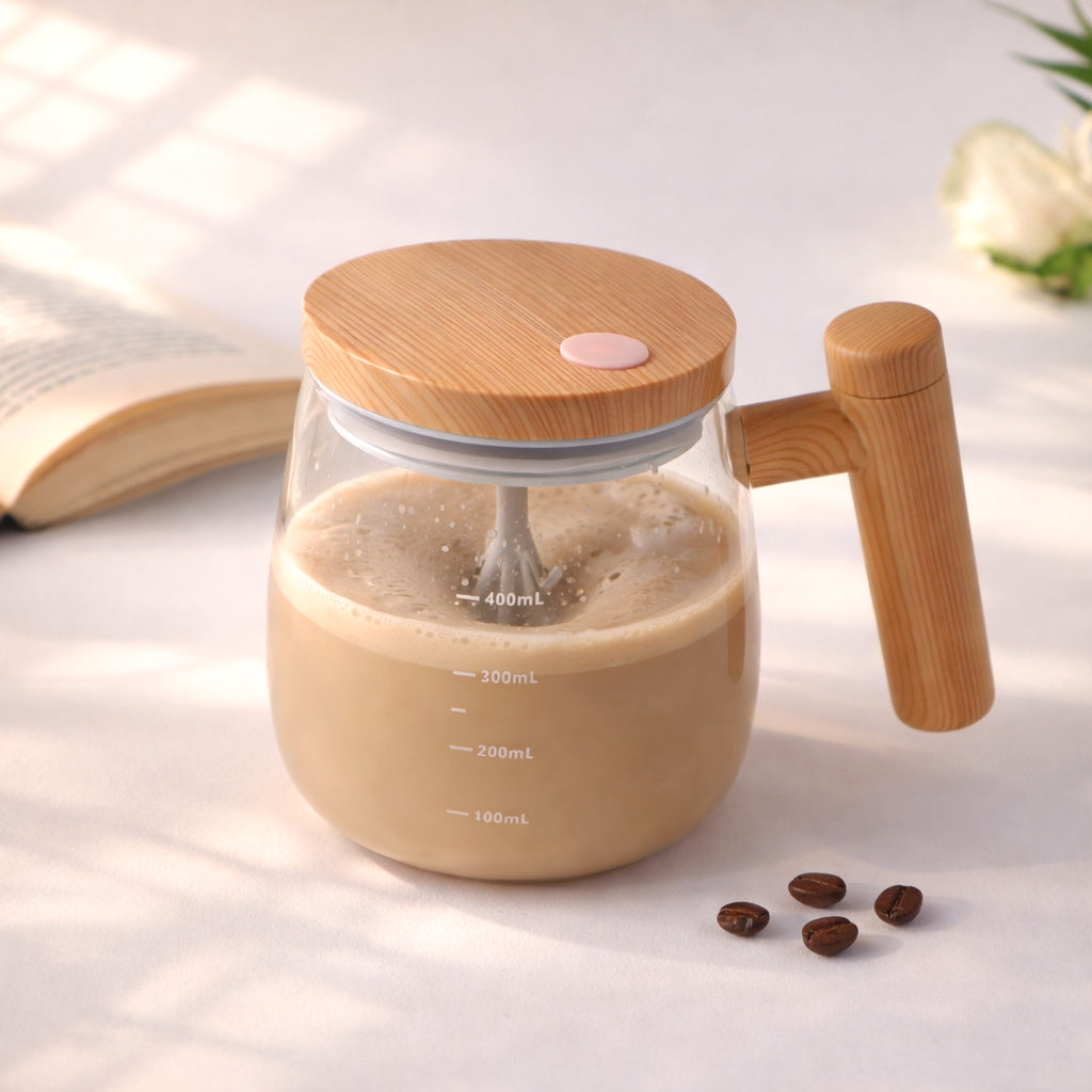 Glass mug with wooden lid and handle filled with a creamy liquid, surrounded by coffee beans on a light surface.